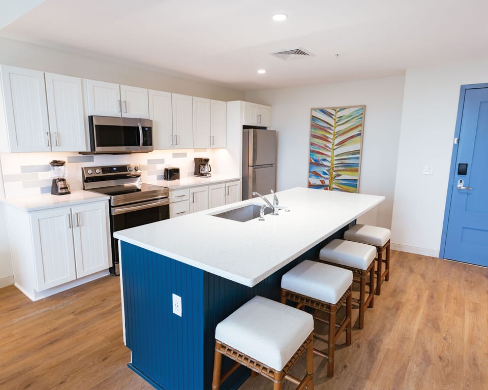Spacious kitchen with a large island and updated appliances, perfect for preparing meals during your stay.