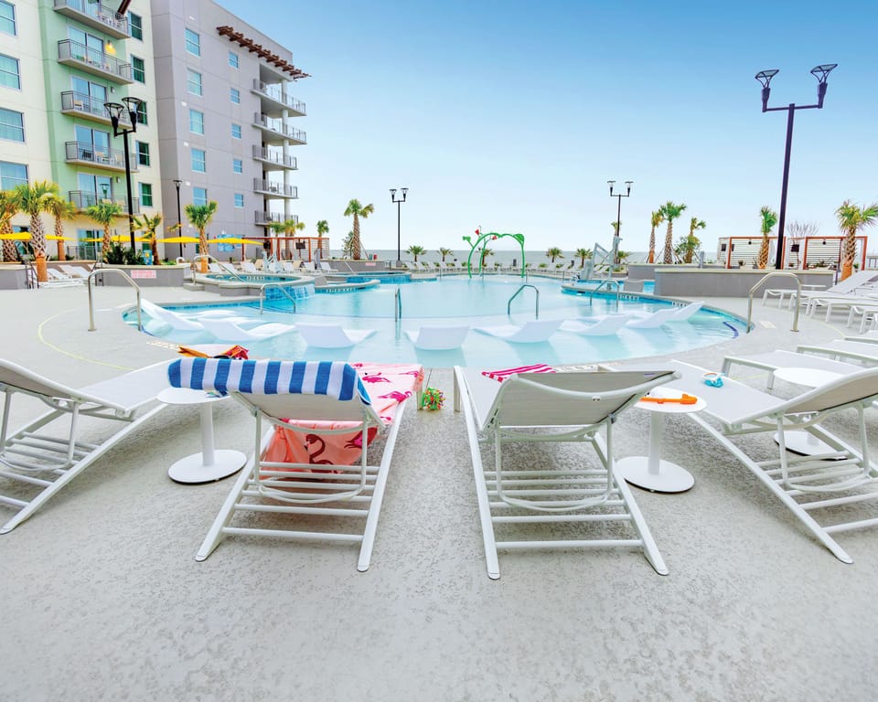 Relax by the oceanfront pool at Myrtle Beach Oceanfront Resort, enjoying stunning beach views.