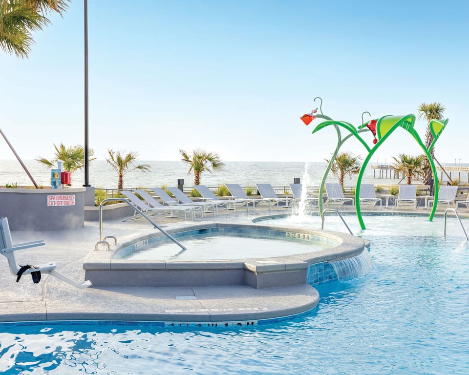 Kids will love the ocean-view water play area, complete with colorful splash features.