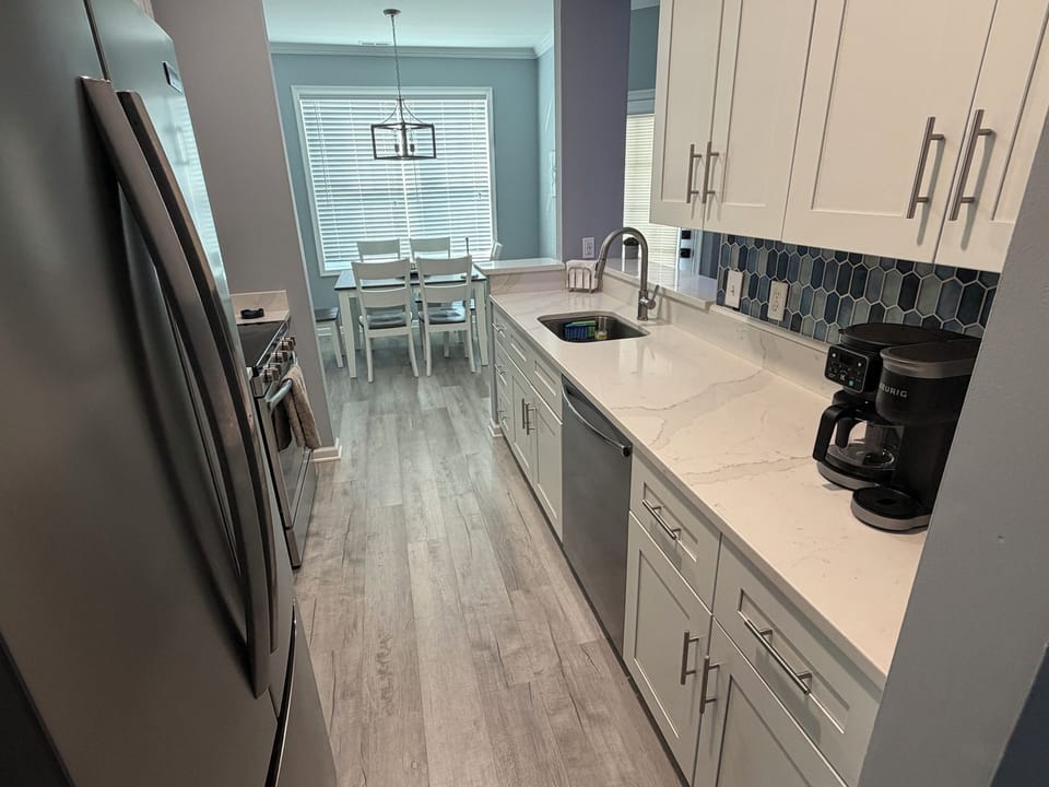 Stylish kitchen with quartz countertops and stainless steel appliances