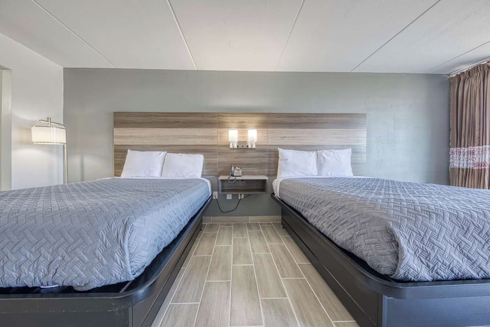 Relax together in two cozy beds under warm, modern lighting.