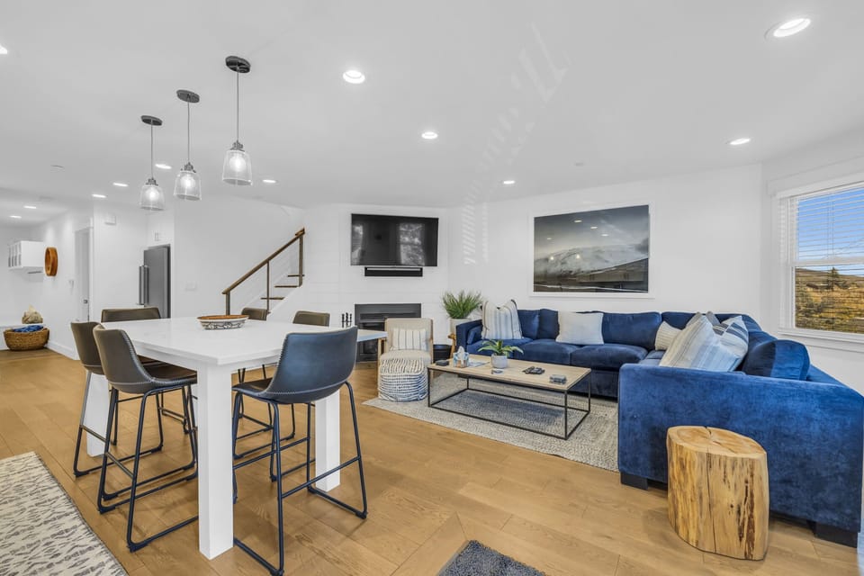 Main Living Space: Open layout, living room, kitchen, dining, chic design, wood-burning fireplace, 65” Smart TV
