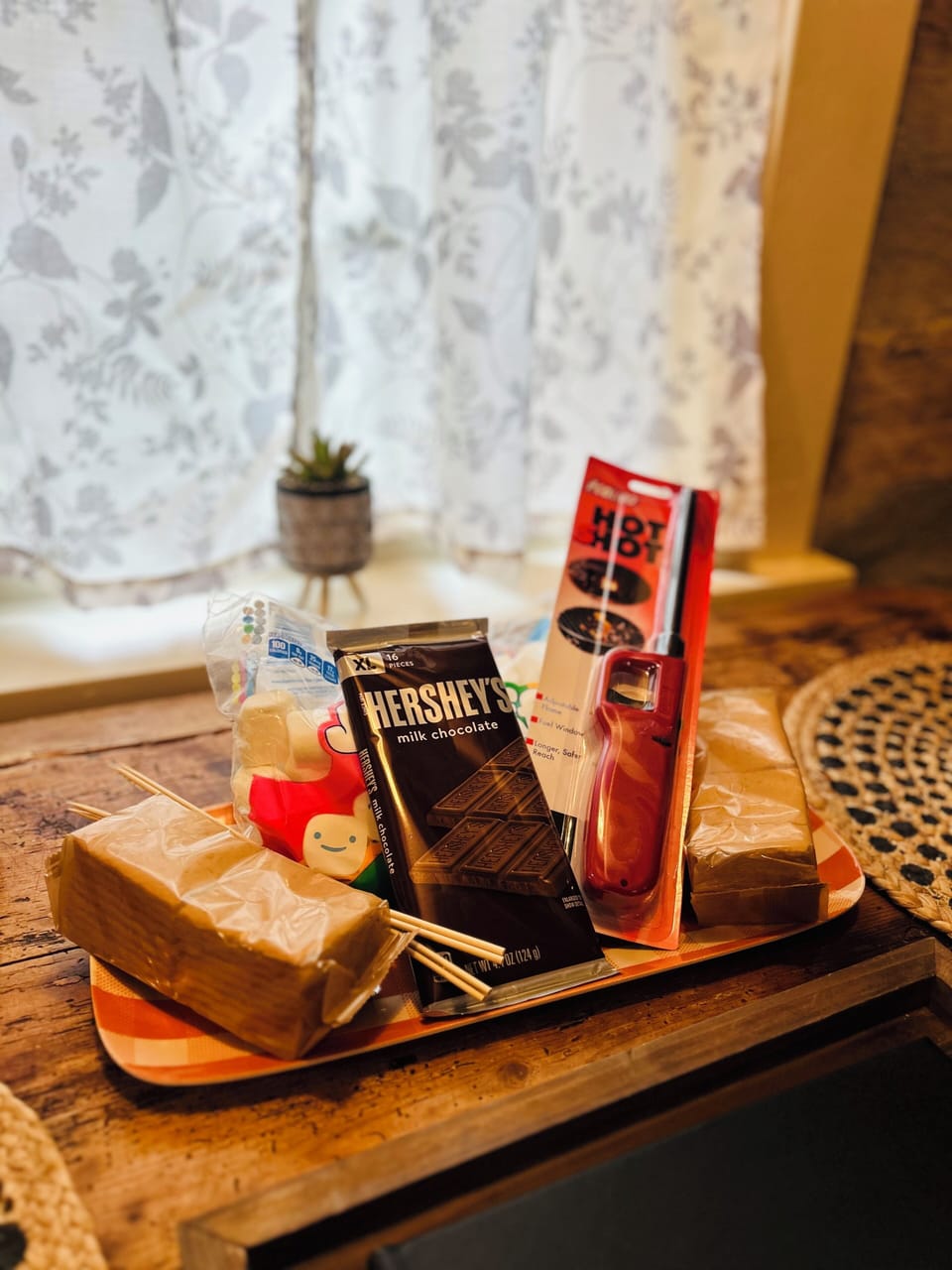 A thoughtful welcome tray offers local treats and small conveniences beside the cabin window.