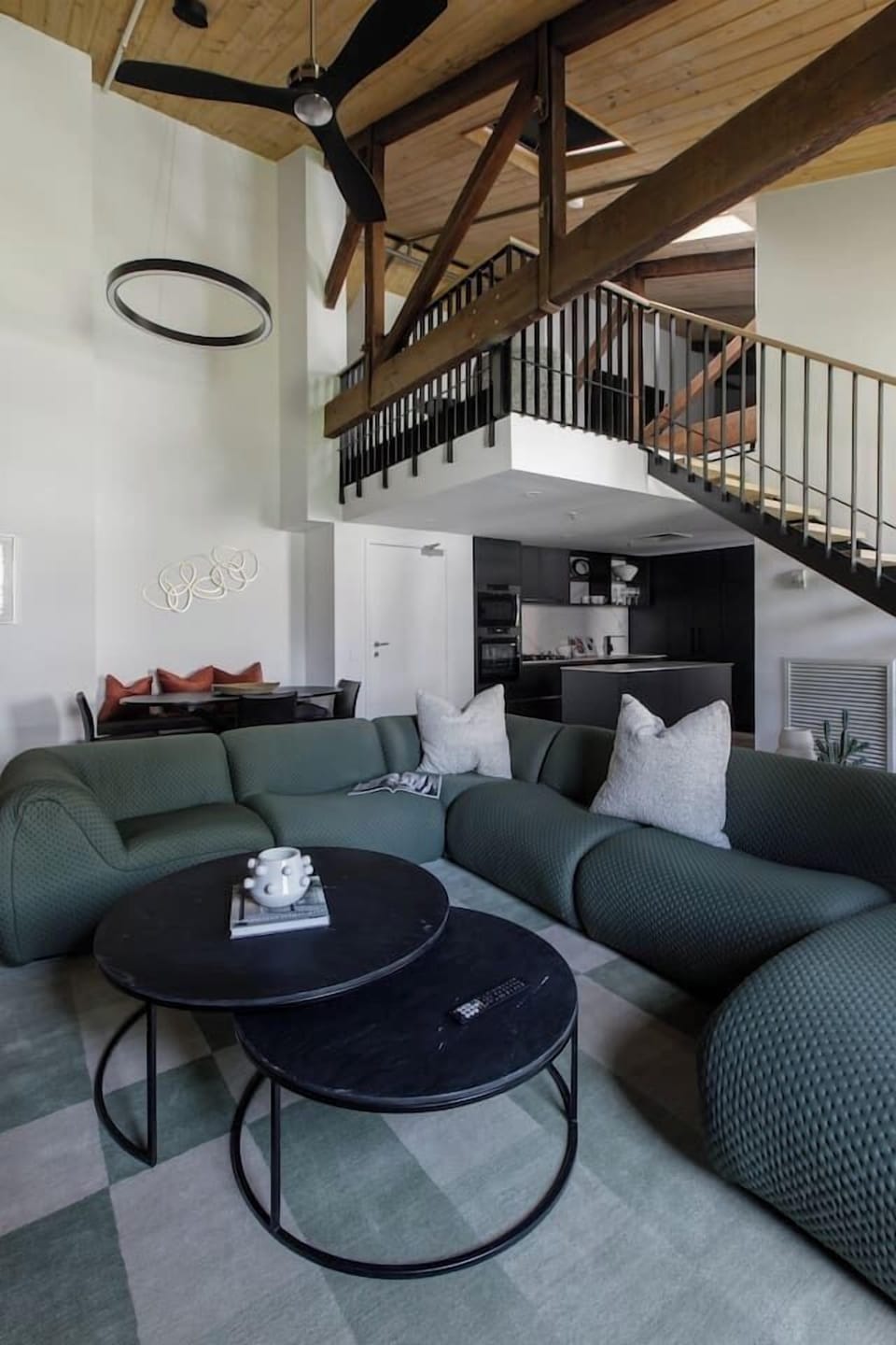 The living space is defined by vaulted timber ceilings and bare brick giving it a loft-like feel.
