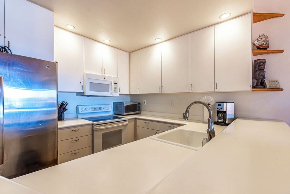 Your fully equipped kitchen offers everything you need to prepare meals with ease, featuring sleek countertops, modern appliances, and plenty of cabinet space for a comfortable stay.