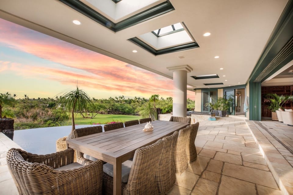 Elegant living area with vaulted open‑beam ceilings and seamless indoor‑outdoor flow — perfect for gathering and relaxation.