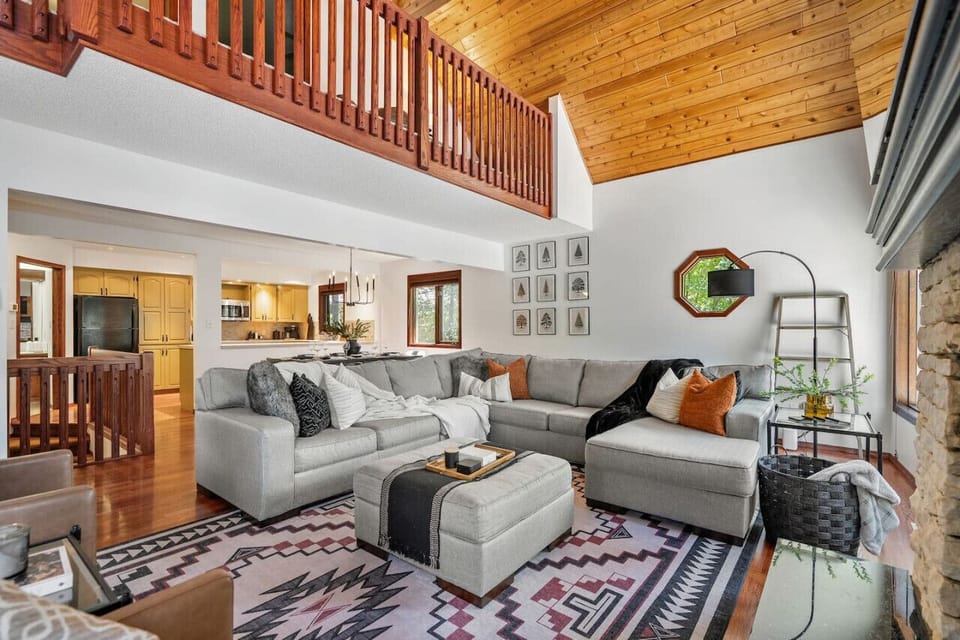 Main floor living room with a wood-burning fireplace, Smart TV and cozy seating options.