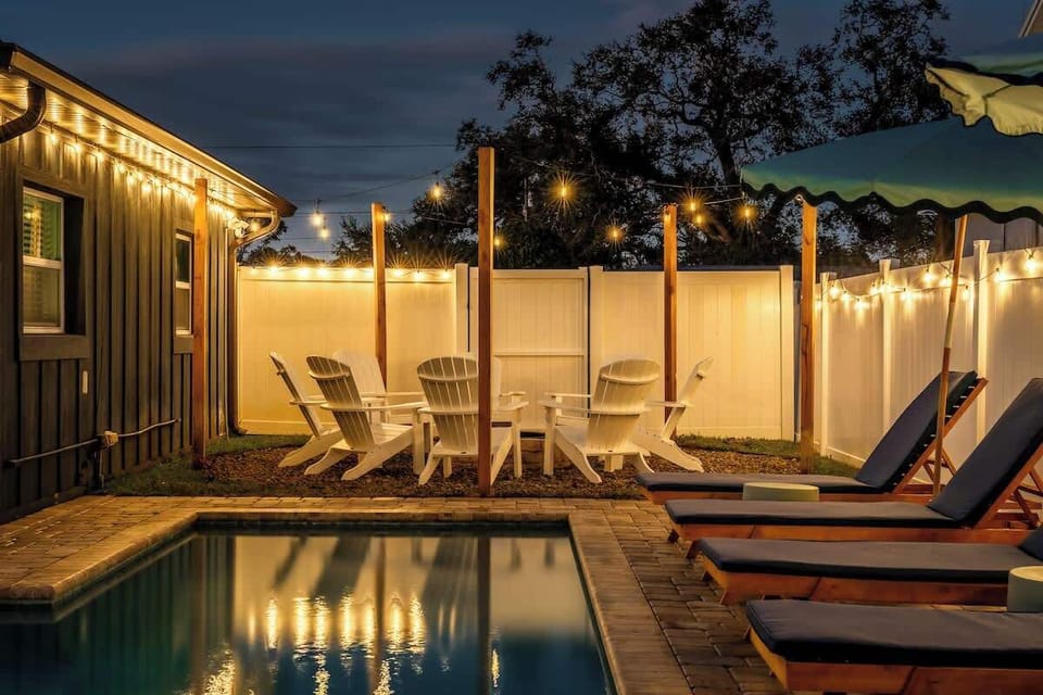 Evening glow by the pool w/ cozy seating & warm lights for relaxed nights outdoors