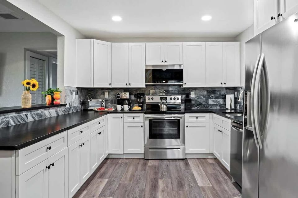Bright kitchen w/ stainless appliances & long counters for easy meal prep