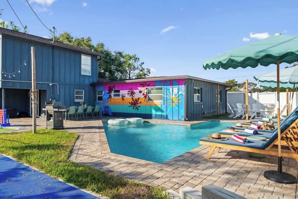 Poolside loungers & umbrellas beside sparkling water for sunny days of relaxation