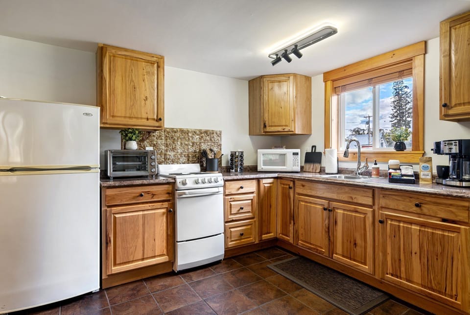Fully stocked for group cooking. No dishwasher, but the kitchen earns its keep.