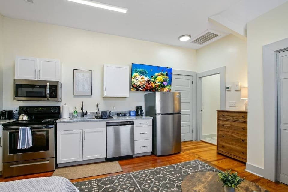 Fully equipped kitchen w/ stainless steel fridge, stove, microwave & plenty of cabinet space
