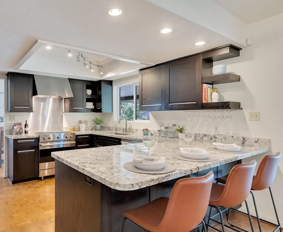 Fully stocked kitchen with high end appliances and cookware.
