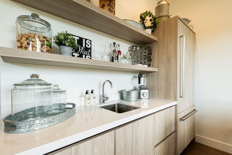 Lower level family room with a wet bar and full-size refrigerator / freezer