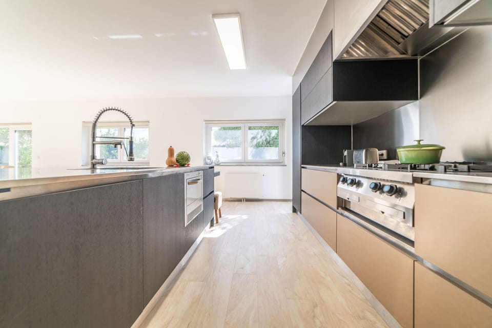 Modern galley kitchen with dual ovens — Villa Geranios, luxury holiday villa in Belverde