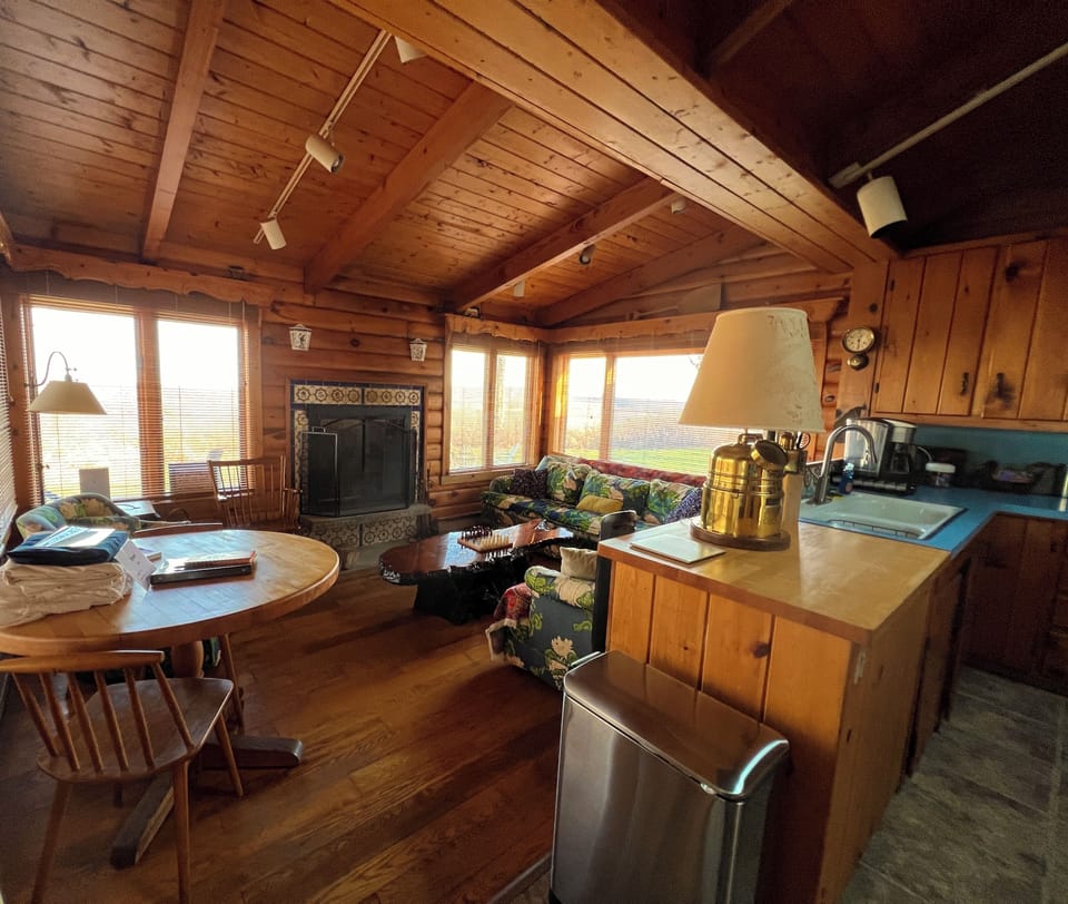 Sitting room with fireplace next to kitchen 