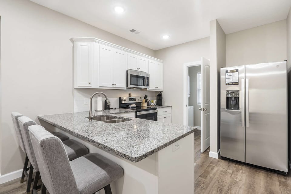 The open, airy kitchen offers ample space & every home comfort