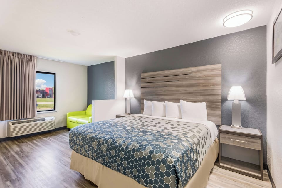 Unwind in a bright king room with cozy seating.