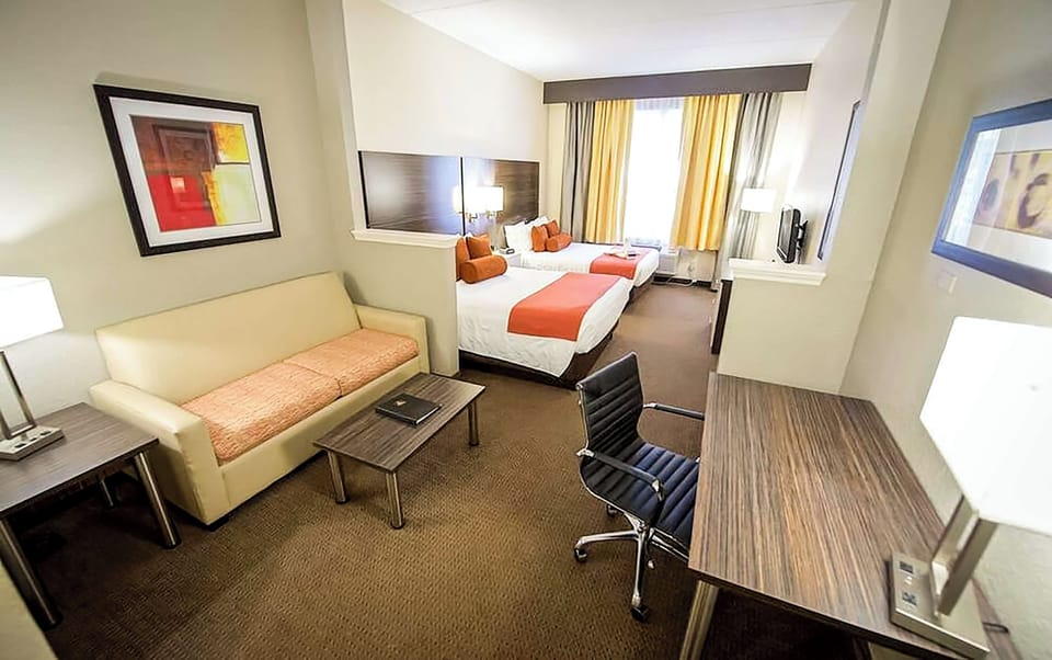 Unwind in a bright suite with cozy bed and workspace.