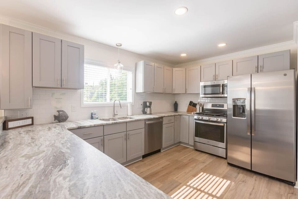 A large kitchen can be found in the heart of the home. Enjoy a gas range, oven, full size refrigerator, microwave, dishwasher, and all the basics you need for cooking. We also provide dining ware for kids and a coffee pot.