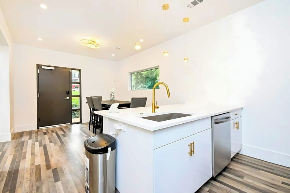 Stylish kitchen flowing into dining area, ideal for meals or takeout nights.