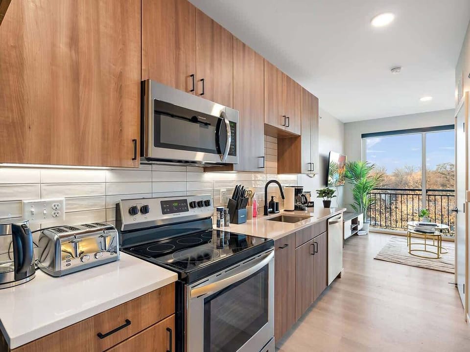 Stylish kitchen with wood cabinetry, modern appliances, and a cozy open layout.