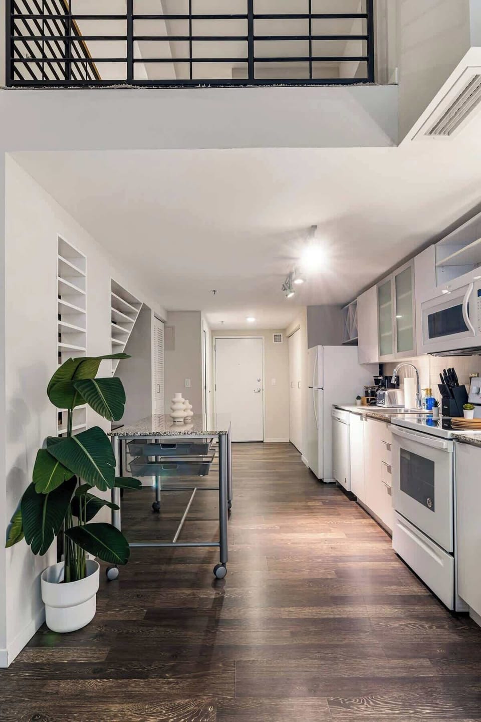 Chic loft kitchen with modern appliances, open layout, and sleek wooden accents.