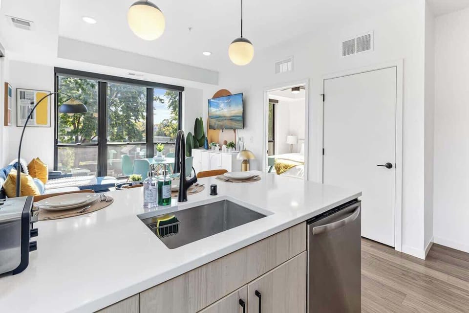 Spacious kitchen with island seating, open living space, and bright natural light.