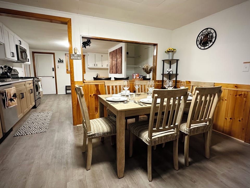 Dining area with a table for 6, a cozy breakfast table for 4, and a bar for 2