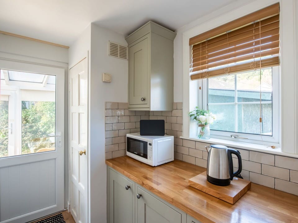 Cabinetry, Property, Countertop, Kitchen Sink, Window, Wood, Kitchen Stove, Kitchen Appliance, Lighting, Houseplant