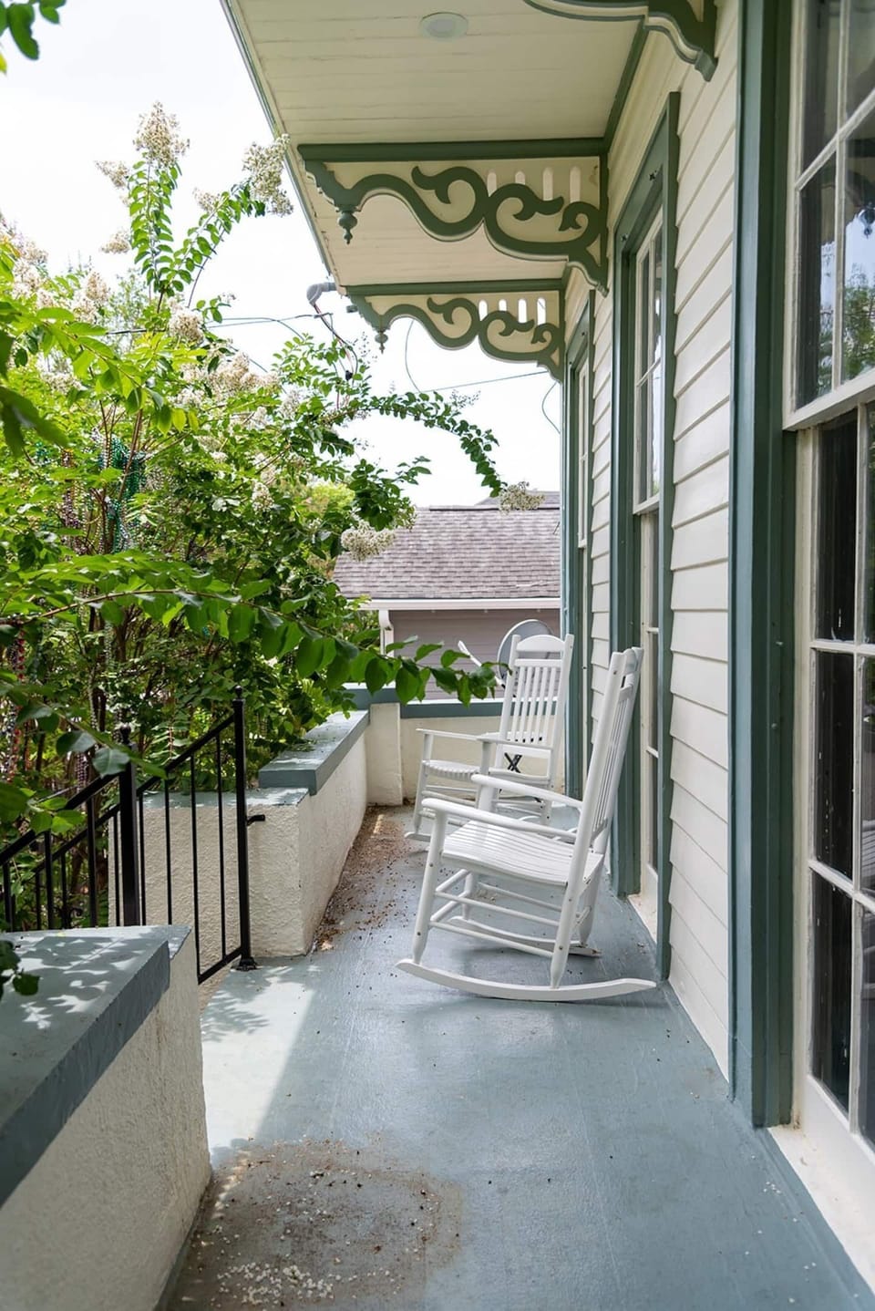Charming balcony framed by lush greenery — a quiet perch to soak it all in.
