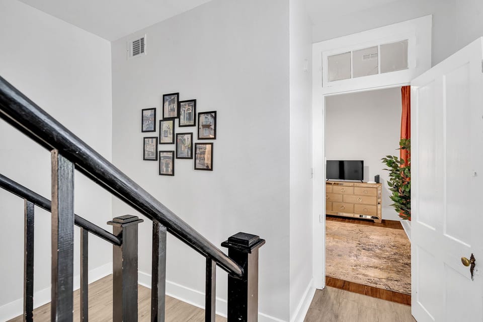 Curated gallery wall adds personality & a personal touch to the staircase landing.
