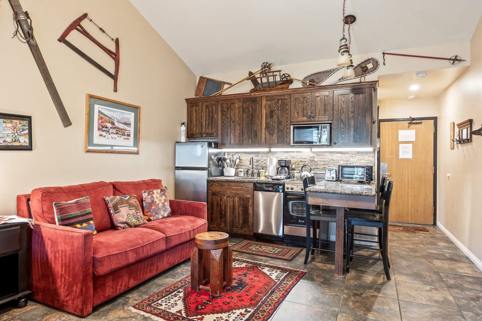 Cozy living space with comfortable seating, bar dining, and a convenient kitchen setup.