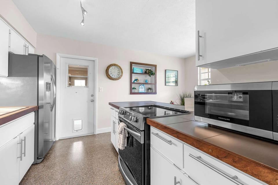 Modern kitchen with stainless steel appliances and ample counter space.