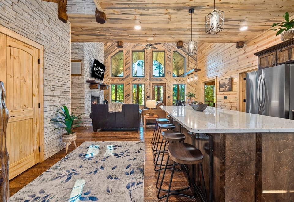 The warm glow from the stone fireplace makes this dining area a cozy spot for meals and memories.