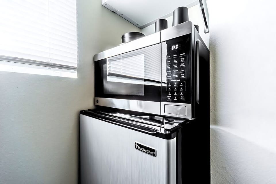 Compact microwave and mini fridge are your secret weapon in this snug space.
