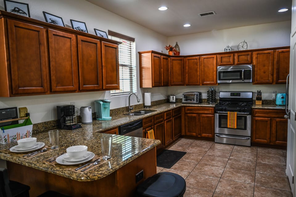 Fully stocked kitchen with a number of kitchen appliances including an air fryer