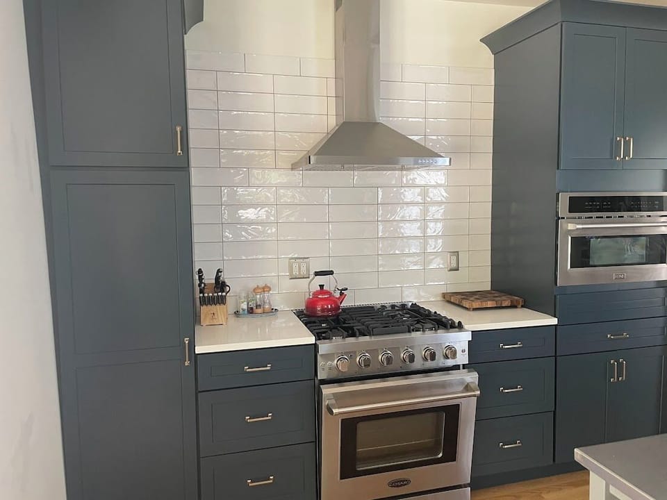 Cook with ease in our fully equipped kitchen featuring a large refrigerator and a 4-burner stove with oven, perfect for preparing meals during your Saugatuck, MI stay.