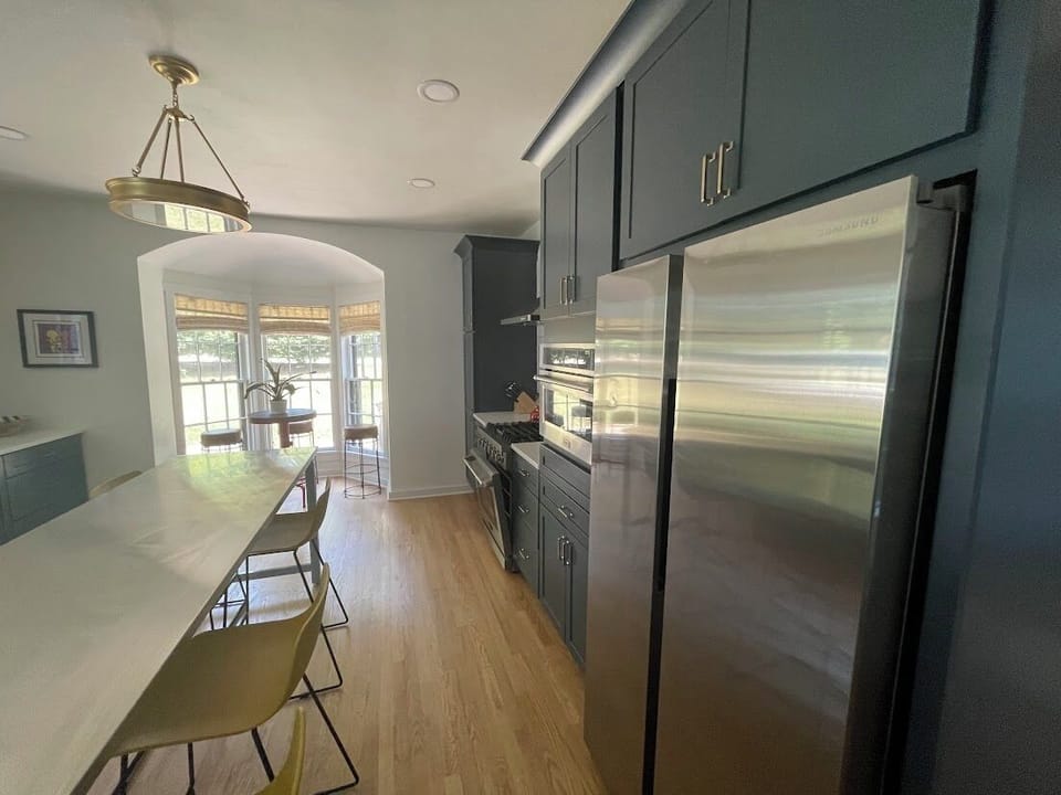 Experience versatile dining in our kitchen with a long island for meal prep and conversation, extra seating for 6, and a charming table for 4 overlooking the garden, perfect for morning coffee or afternoon tea in Saugatuck.