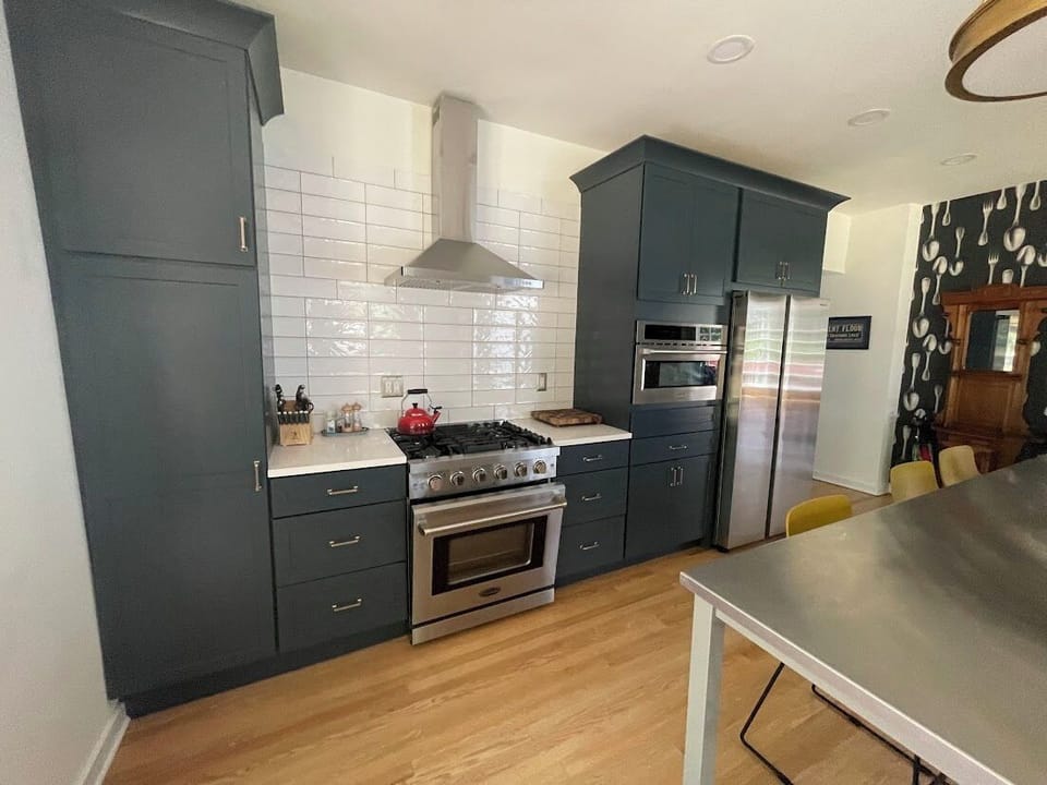 Gather and cook in our spacious kitchen featuring a long island for meal prep and socializing, plus extra dining space for 6, enhancing your culinary experience in Saugatuck.