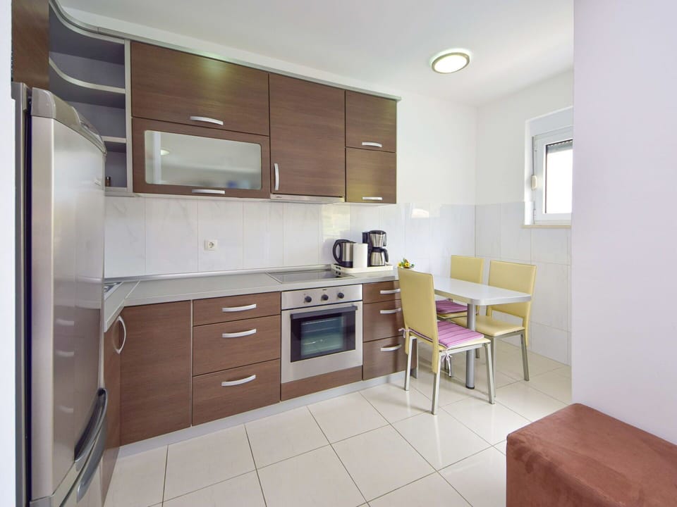 Cabinetry, Furniture, Countertop, Building, Kitchen Stove, Drawer, Wood, Kitchen Appliance, Window, Home Appliance