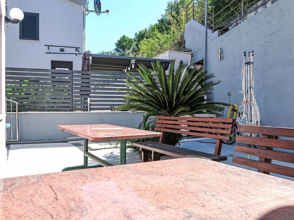 Furniture, Outdoor Furniture, Floor, Table, Outdoor Table, Flowerpot, Shade, Chair, Houseplant, Courtyard