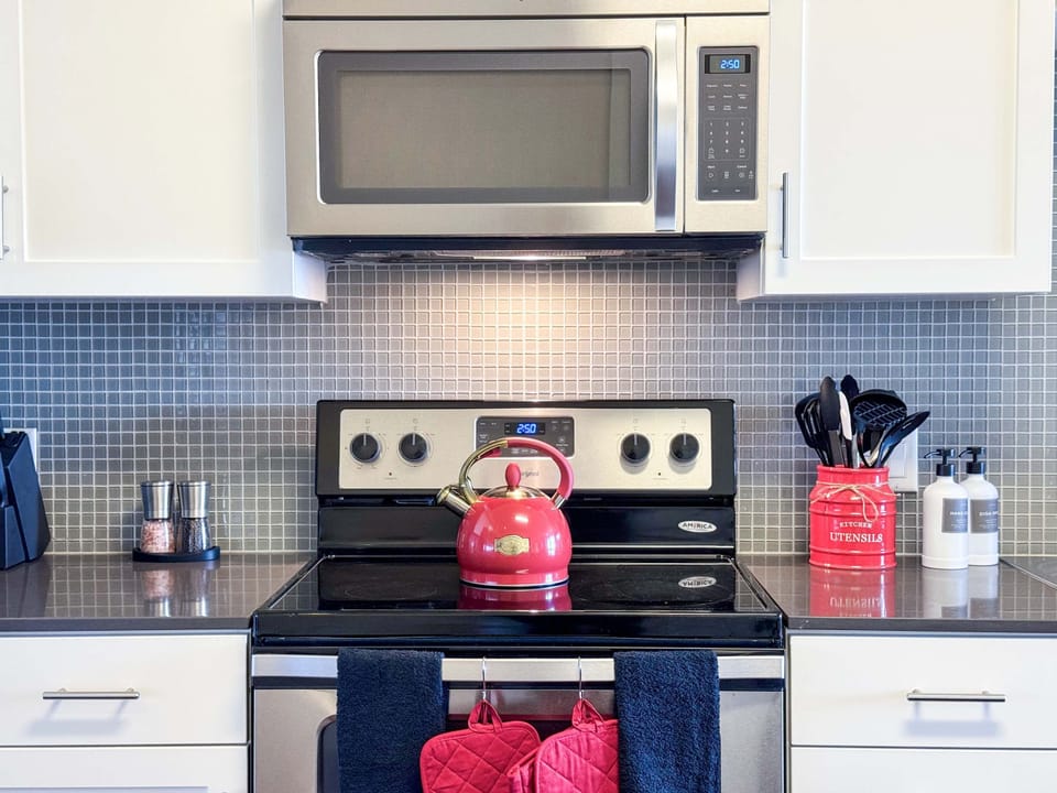 Fully equipped kitchen ideal for extended stays, complete with pots, pans, dinnerware, and glassware.