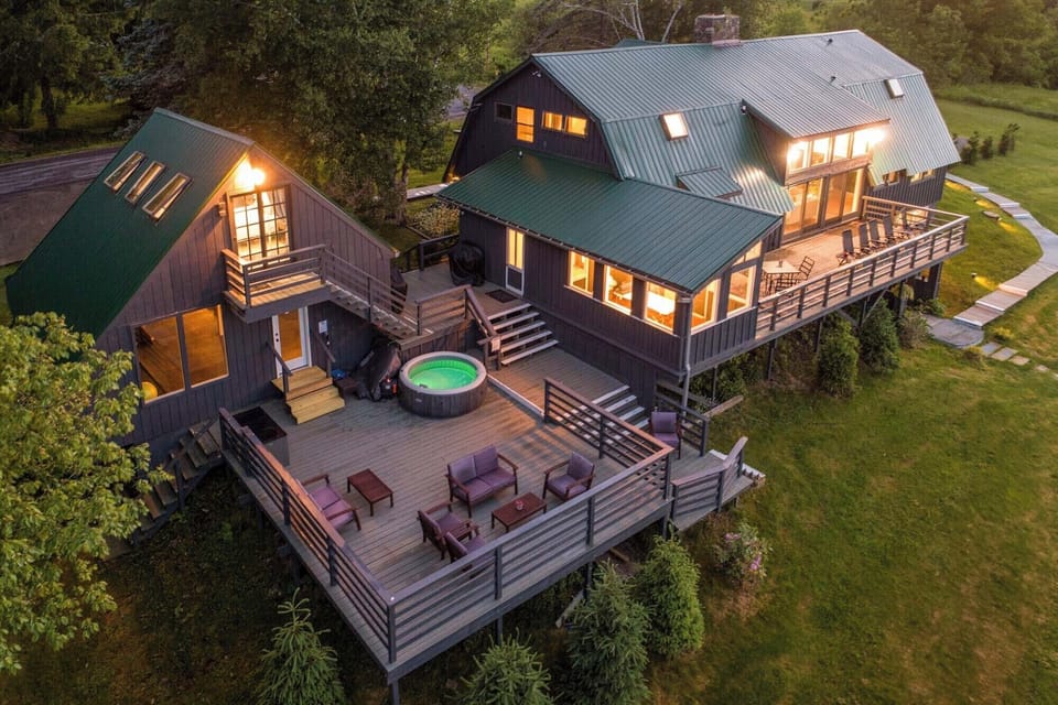 The current hot tub is down the left stairs on the ground and open year-round.