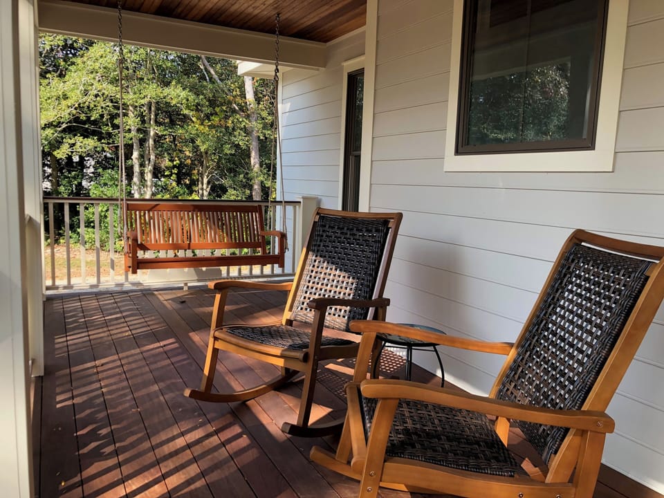 Front porch with rocking chairs and swing 
