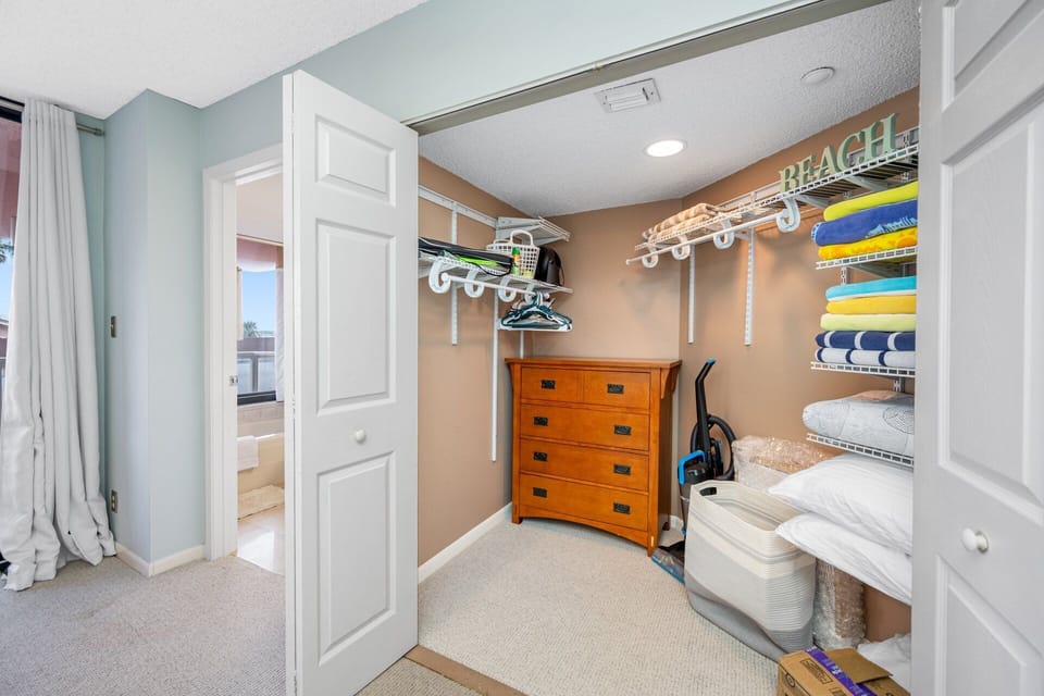 Walk in closet with beach towels
