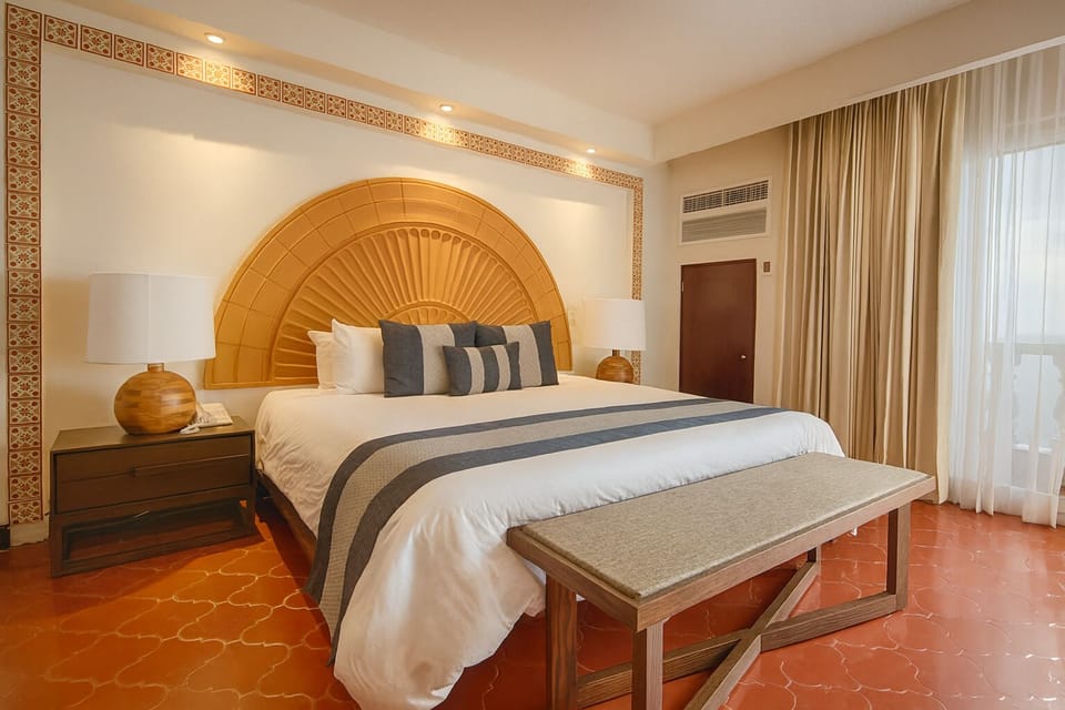Sink into a king bed framed by glowing, elegant decor.
