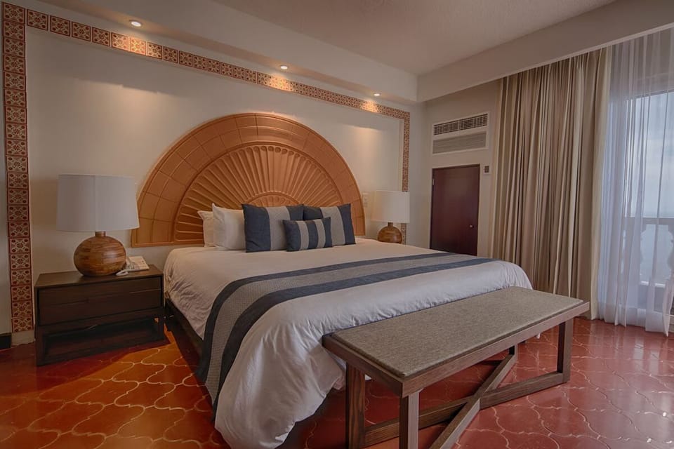 Drift off beneath warm accent lighting and resort-style bedding.
