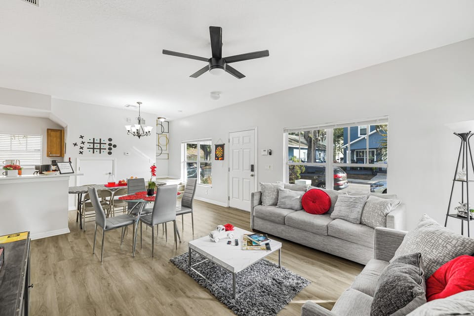 Bright and inviting living room with fireplace, large TV, and family games