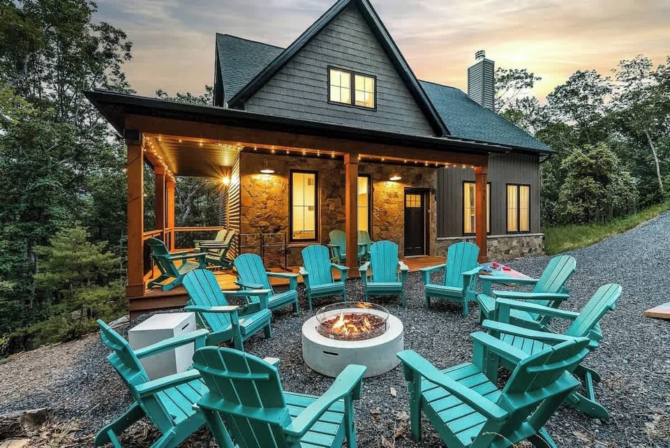 Gather around the outdoor firepit surrounded by Adirondack chairs under the trees
